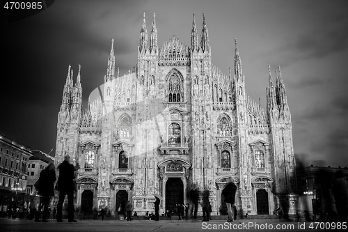 Image of Milan Cathedral , Duomo di Milano, is the gothic cathedral church of Milan, Italy. Shot in the dusk from the square ful of people.