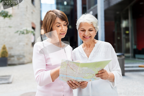 Image of senior women with city map on street in tallinn