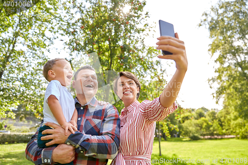 Image of happy family taking selfie at summer park