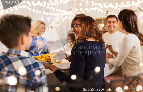 Image of happy family having dinner party at home