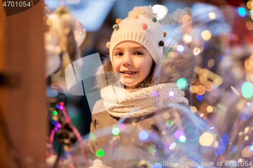 Image of happy little girl at christmas market in winter