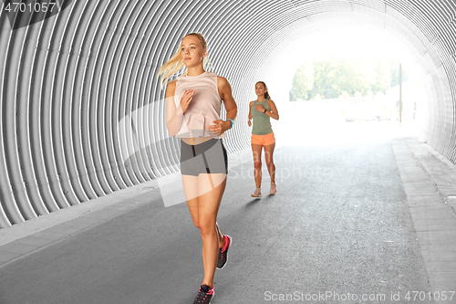 Image of young women or female friends running outdoors