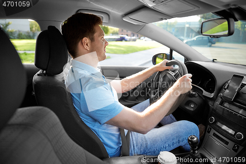 Image of smiling man or driver driving car