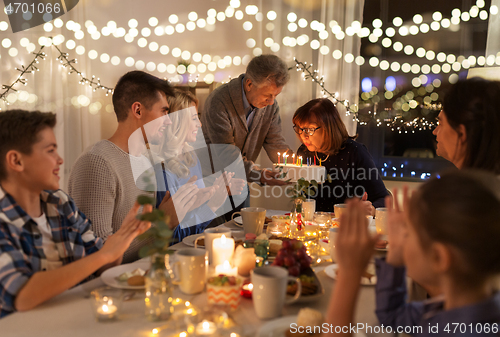 Image of happy family having birthday party at home