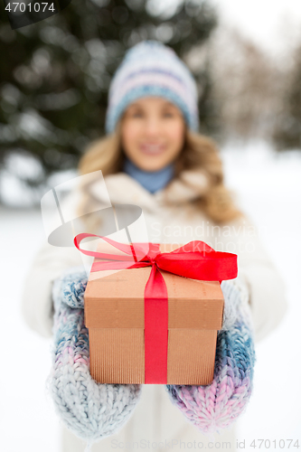 Image of close up of woman with christmas gift in winter