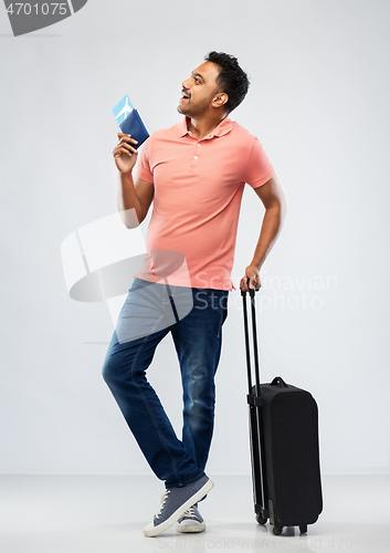 Image of indian man with travel bag passport and air ticket