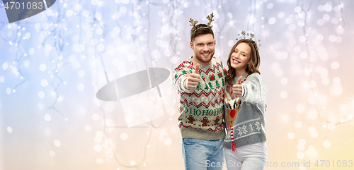 Image of happy couple at christmas ugly sweater party