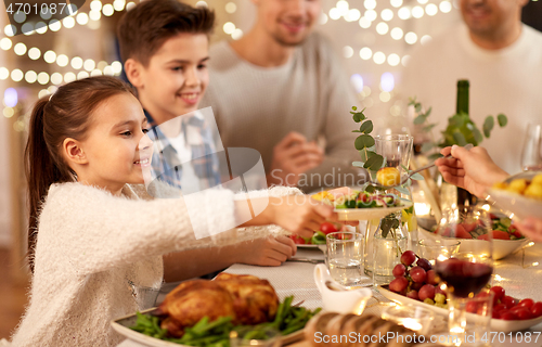 Image of happy family having dinner party at home