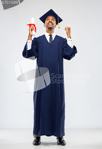 Image of male graduate student in mortar board with diploma