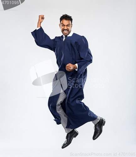 Image of happy indian graduate student celebrating success