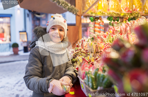 Image of little girl choosing sweets at christmas market