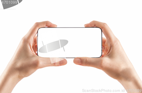 Image of Young girl hands holding black smart phone on white 