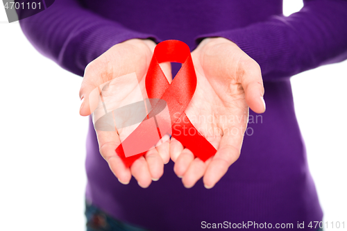 Image of Woman is holding the red awareness ribbon