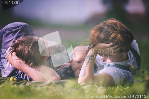 Image of hipster family relaxing in park