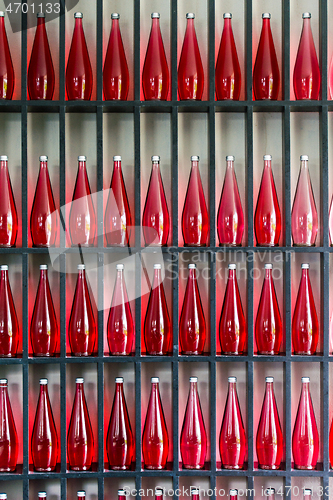 Image of bottles of red juice in modern restaurant