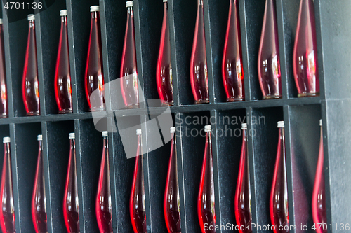 Image of bottles of red juice in modern restaurant