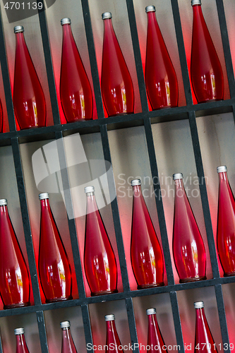 Image of bottles of red juice in modern restaurant