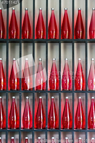 Image of bottles of red juice in modern restaurant