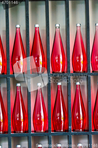 Image of bottles of red juice in modern restaurant