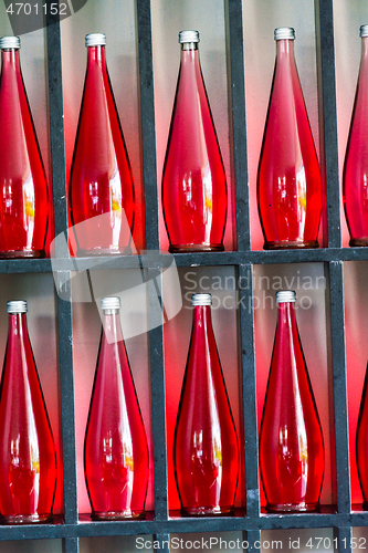 Image of bottles of red juice in modern restaurant