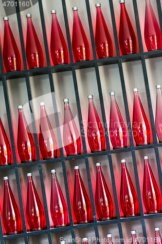 Image of bottles of red juice in modern restaurant