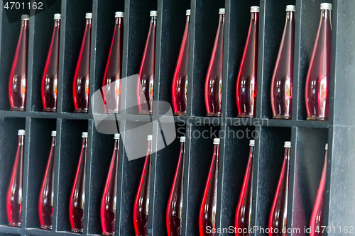 Image of bottles of red juice in modern restaurant