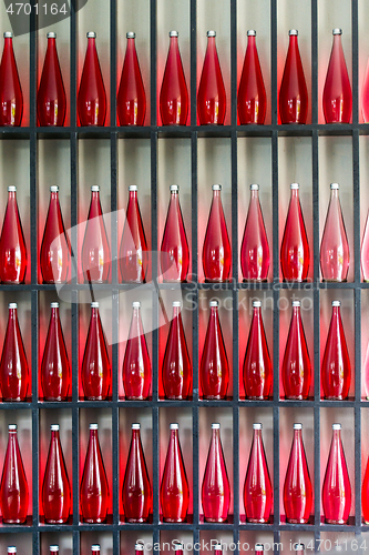 Image of bottles of red juice in modern restaurant