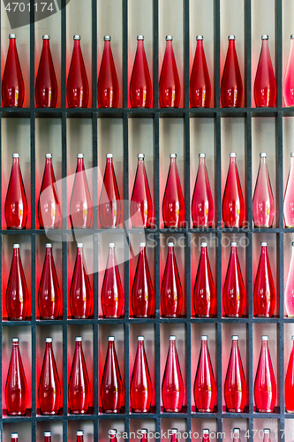 Image of bottles of red juice in modern restaurant