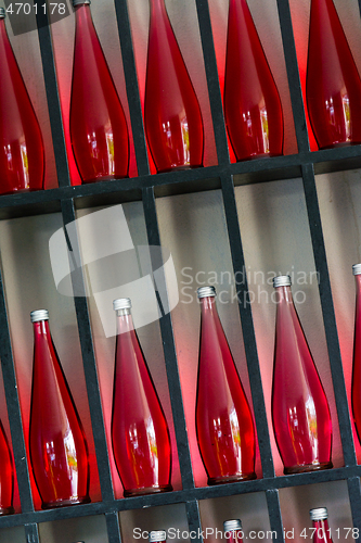 Image of bottles of red juice in modern restaurant