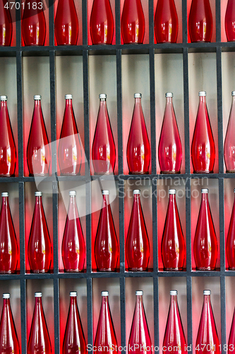 Image of bottles of red juice in modern restaurant