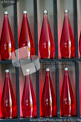 Image of bottles of red juice in modern restaurant