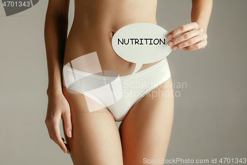 Image of Women belly with the drawing word NUTRITION.