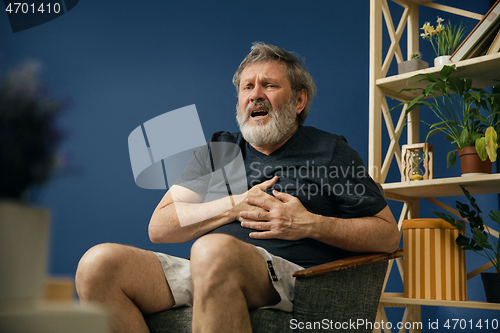 Image of Old bearded man suffering from pain