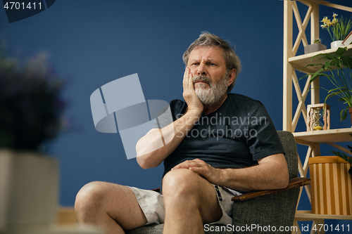 Image of Old bearded man suffering from pain