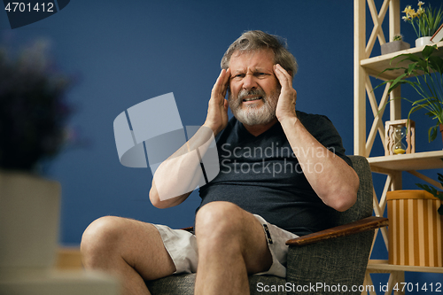 Image of Old bearded man suffering from pain