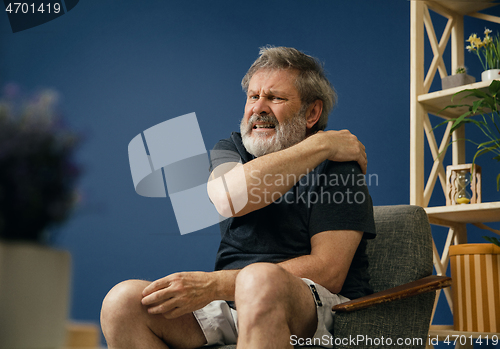 Image of Old bearded man suffering from pain