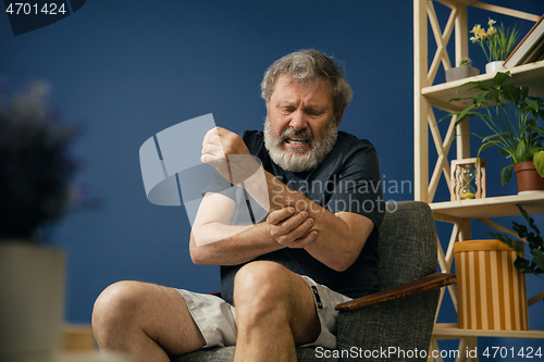 Image of Old bearded man suffering from pain