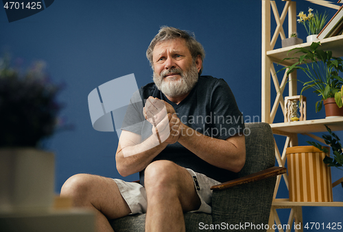 Image of Old bearded man suffering from pain