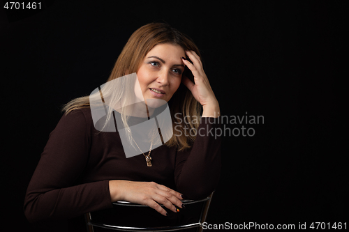 Image of Portrait of a forty-year-old beautiful European woman on a black background