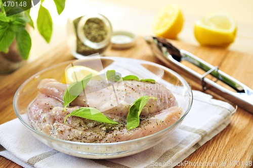 Image of Raw chicken breasts marinating
