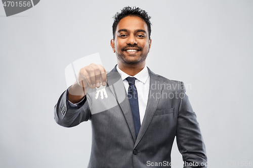 Image of indian man realtor with keys and folder