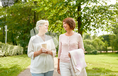 Image of senior women or friends drinking coffee at park