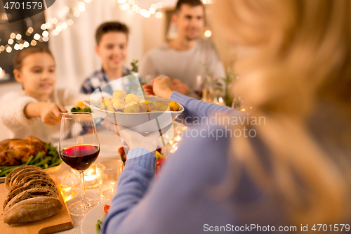 Image of happy family having dinner party at home