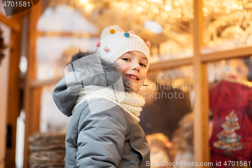 Image of happy little girl at christmas market in winter