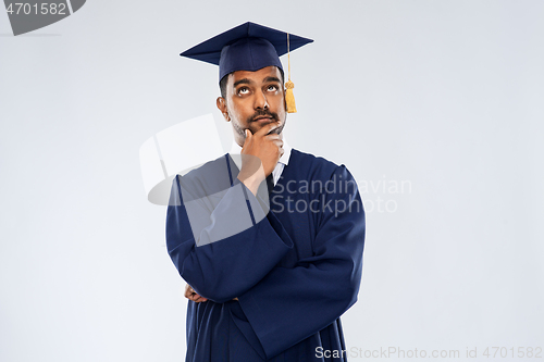 Image of graduate student in mortar board thinking