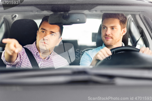 Image of car driving school instructor teaching male driver