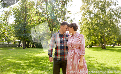 Image of happy couple in summer park