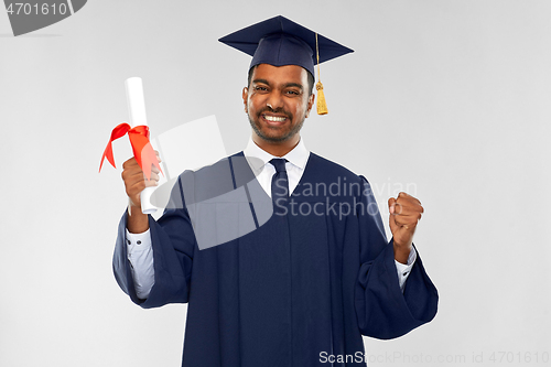 Image of happy graduate student in mortarboard with diploma