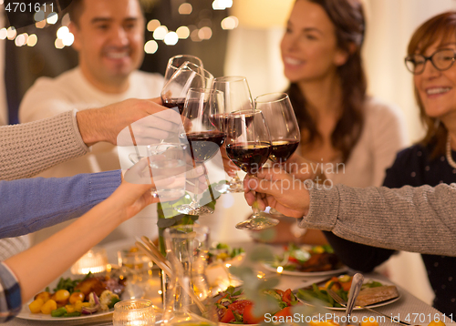 Image of happy family having dinner party at home