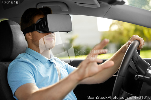 Image of man or driver wearing vr glasses and driving car